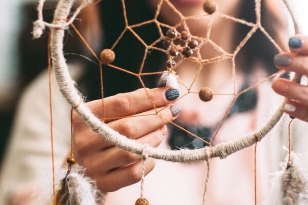 Master shows finished Dreamcatcher in art studio. This series have lot of colorful photos about how to make dream catchers